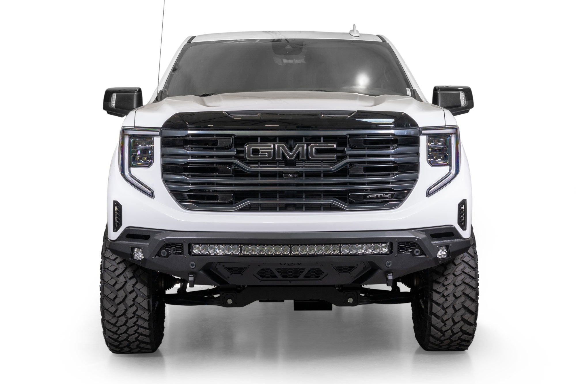 Front view of a white GMC Sierra 1500 with Stealth Fighter Front Bumper on a white background
