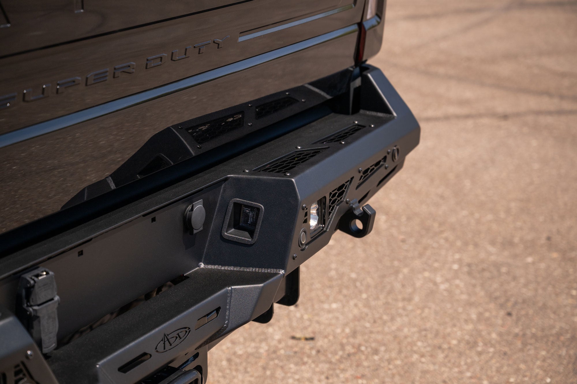 Retaining the OOEM license lights, pugs, and hitch on the Stealth Fighter Rear Bumper for 2023-2026 Ford Super Duty