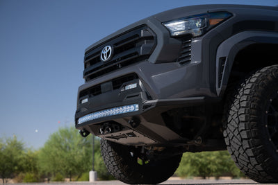 Close-up of a Stealth Fighter Winch Front Bumper for the 4th Gen Toyota Tacoma with a clear sky background. 