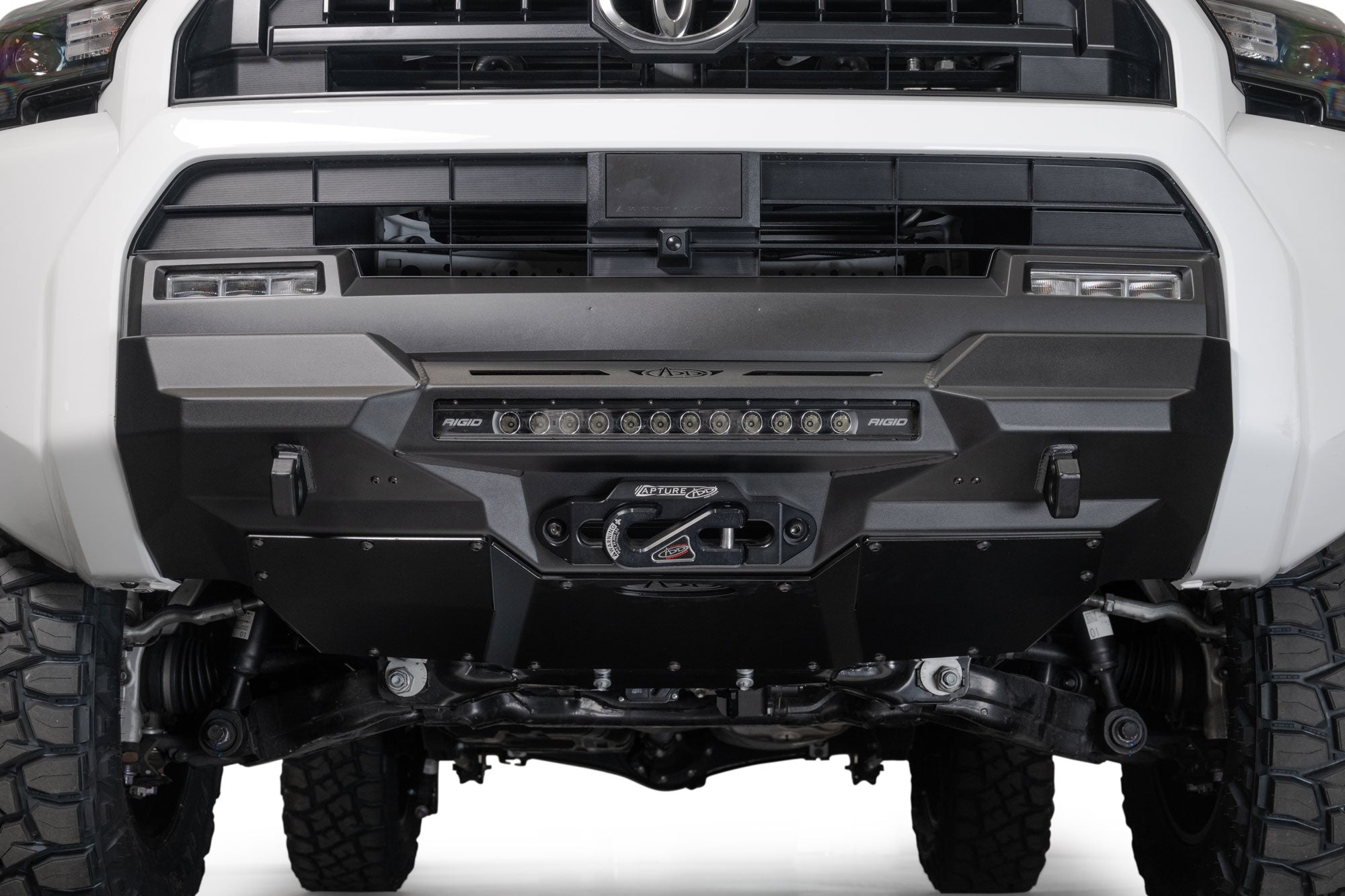 Front view of a 2025 Toyota 4Runner Stealth Center Mount Front Bumper and off-road tires on a white background