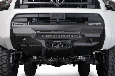 Front view of a 2025 Toyota 4Runner Stealth Center Mount Front Bumper and off-road tires on a white background