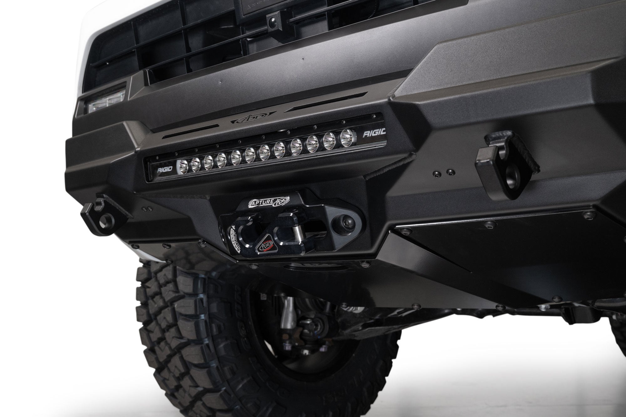 Close-up of a 2025 Toyota 4Runner Stealth Center Mount Front Bumper with off-road lights on a white background