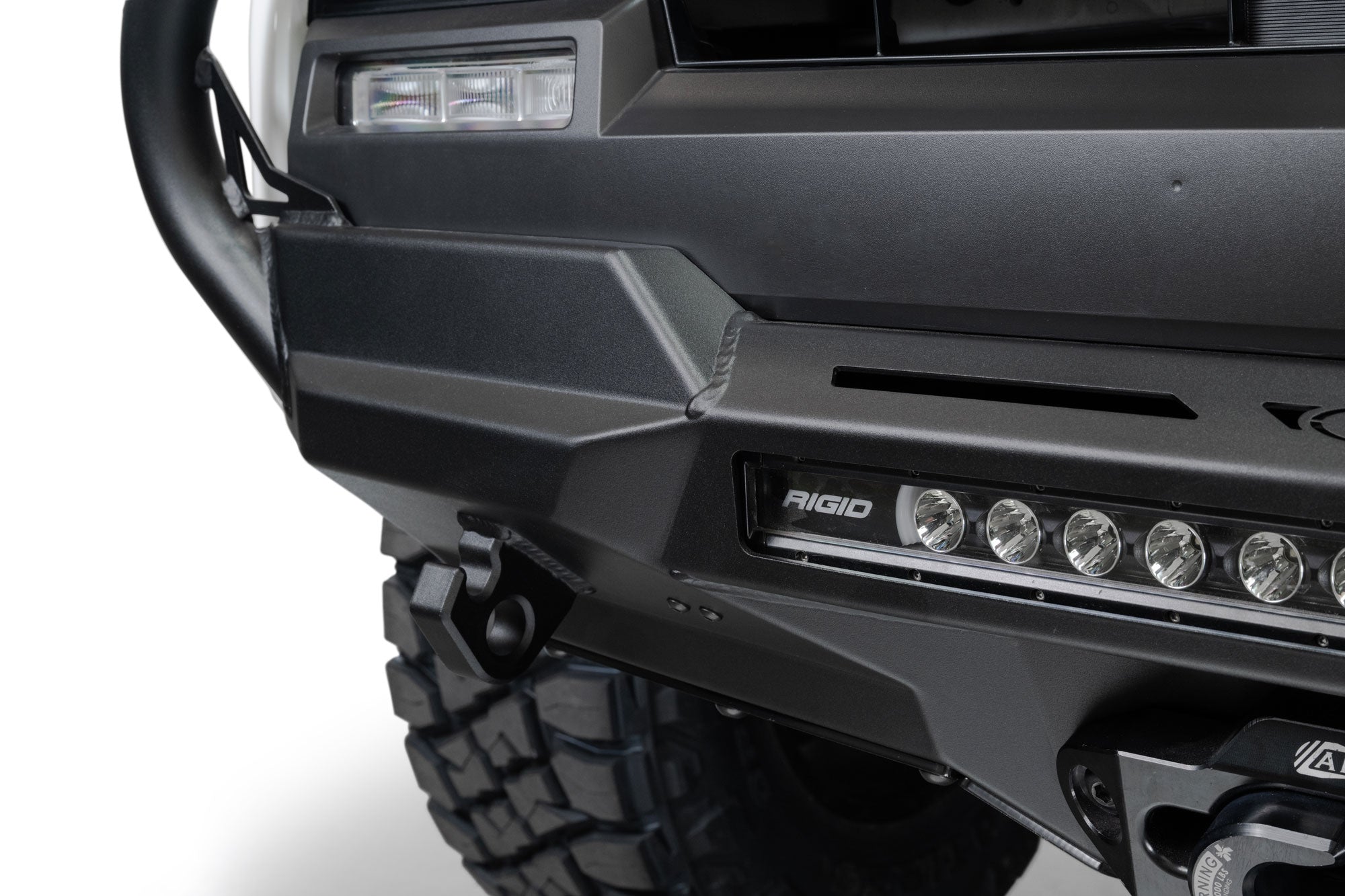Close-up of a vehicle's front bumper with Rigid LED light bar on a white background