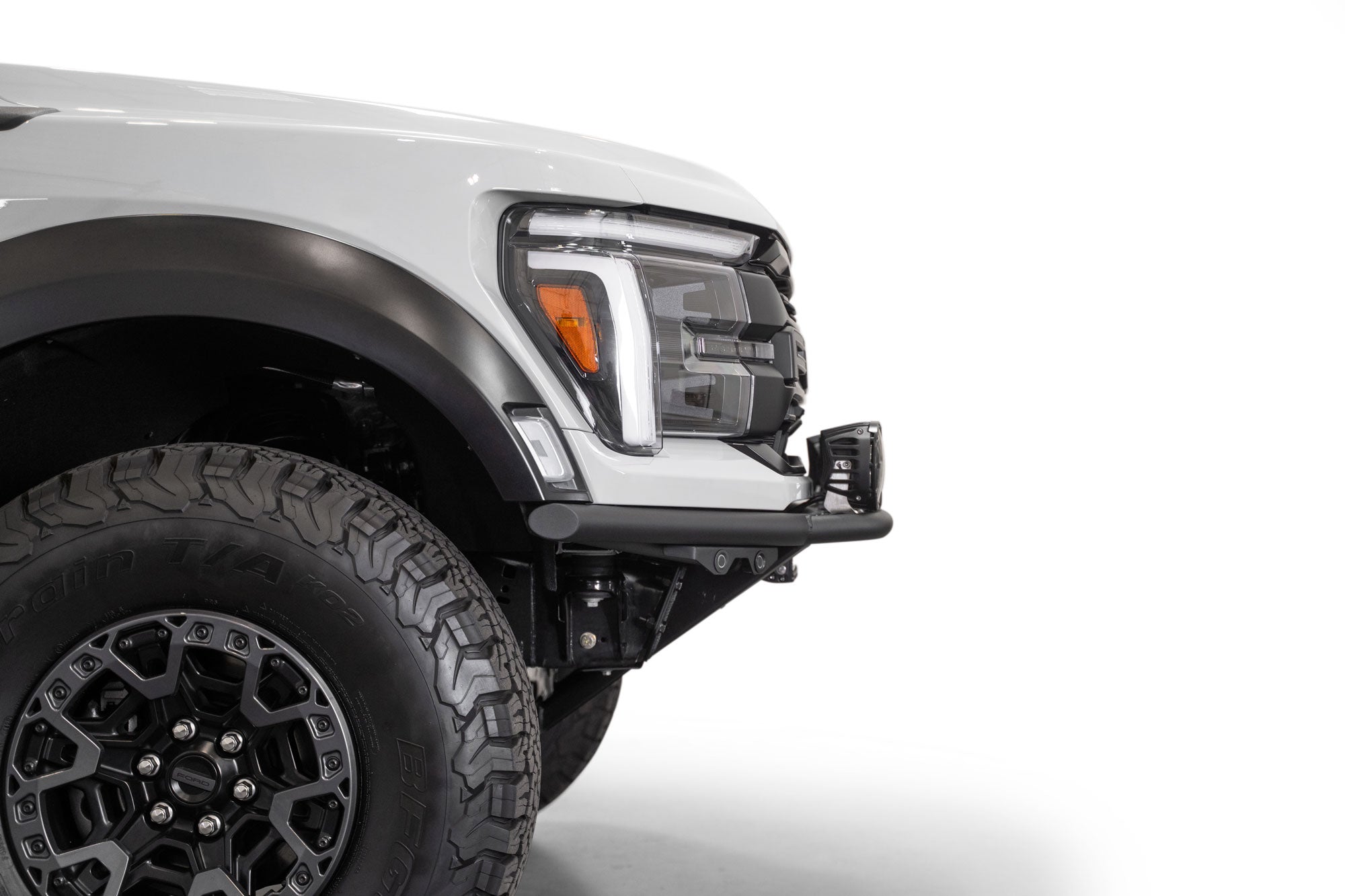 Side profile view of installed 2021+ Ford F-150 Raptor Pro Plus Frame Cut Front Bumper that leaves a lot of clearance