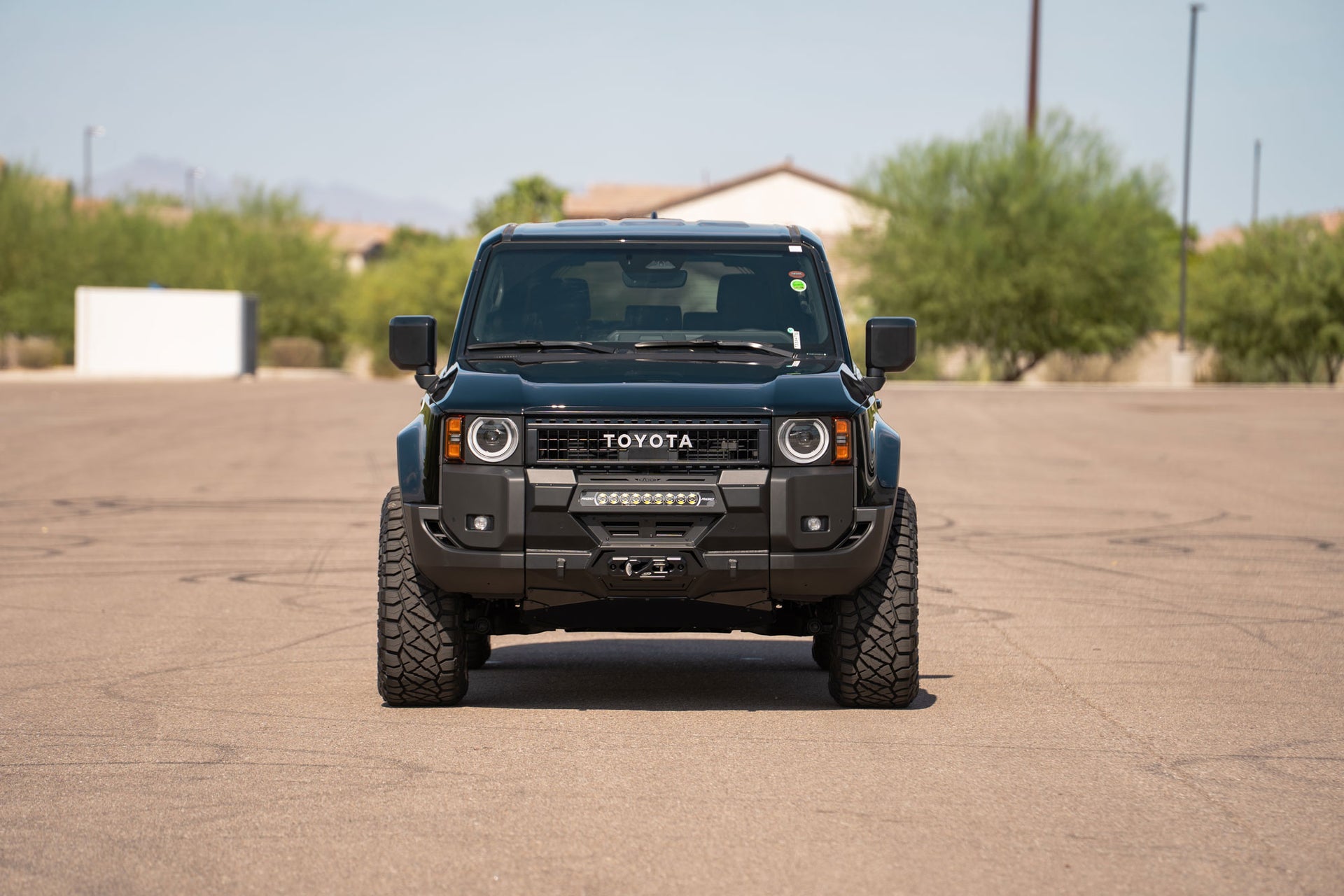 Front view of parked Toyota Land Cruiser Stealth Center Mount Winch Front Bumper for 2024+ vehicles installed with skid plate option 