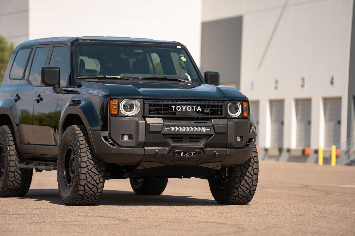 Stealth Center Mount Winch Front Bumper for 2024+ Toyota Land Cruiser installed on vehicle parked in front of warehouse building