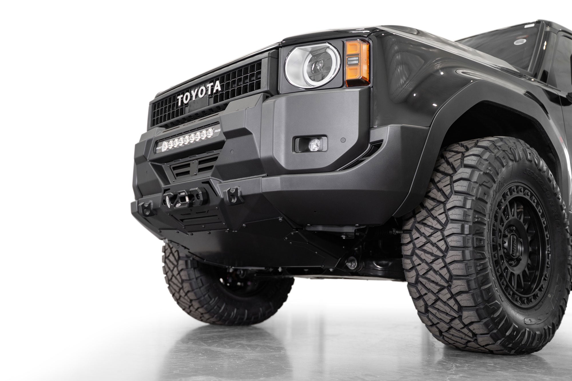 Low angle view of installed 250 series Toyota Land Cruiser Stealth Center Mount Winch Front Bumper for 2024 and newer vehicles