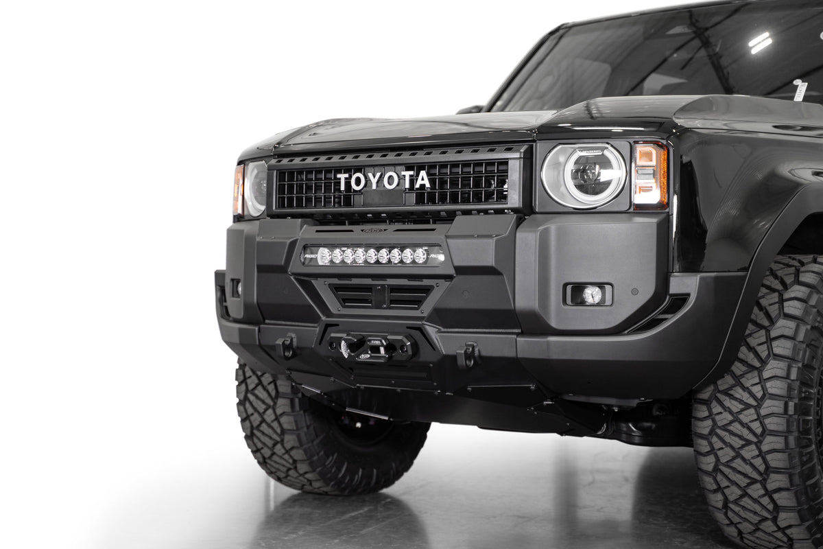 Angled view of Toyota Land Cruiser Stealth Center Mount Winch Front Bumper for 2024 and newer vehicles installed with skid plate option