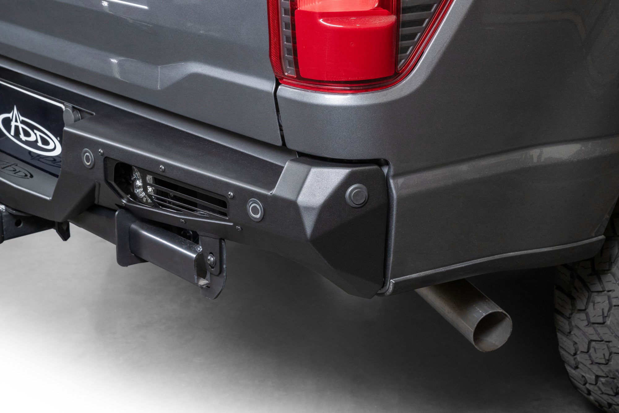 Angled view of 2024+ Ford F-150 Bomber Rear Bumper on dark gray Ford pickup