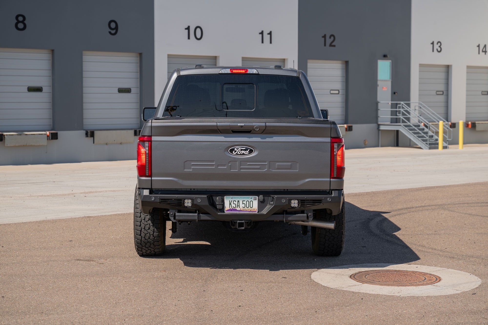 Ford F-150 parked in warehouse lot with Ford F-150 Bomber Rear Bumper freshly installed
