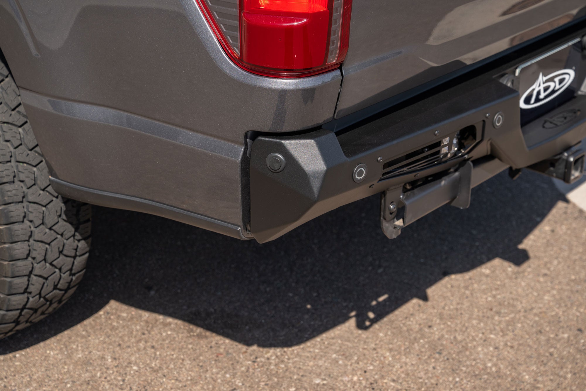 Close angle-view of installed 2024+ Ford F-150 Bomber Rear Bumper showing precision fitment and OEM sensor functionality