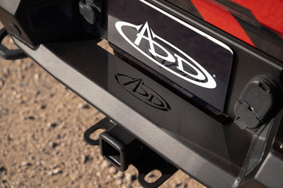 Close-up of a Phantom Rear Bumper showing the retained hitch receiver on a dirt background